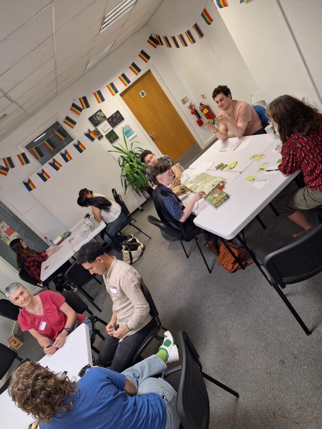 photo of people playing board games at Pride Place