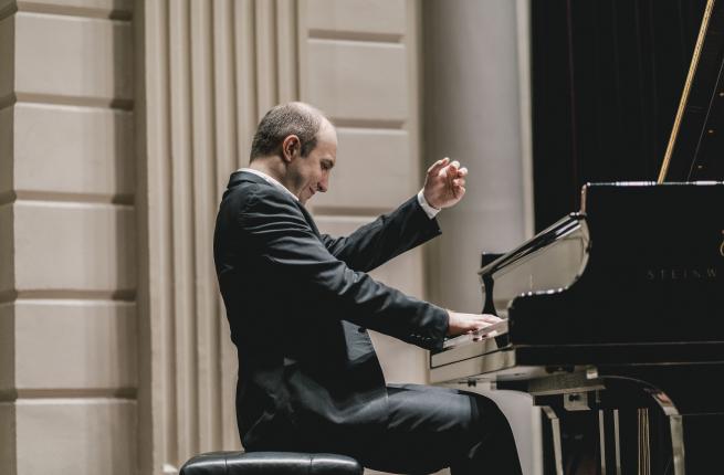 A musician performing at a piano. 