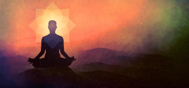 A silhouette of an individual meditating.