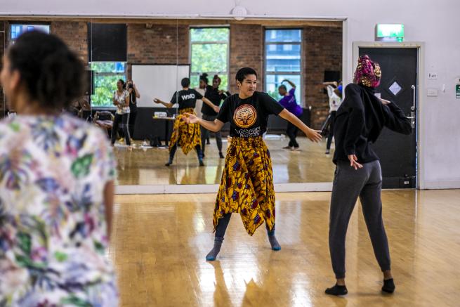 Different people dance in a studio