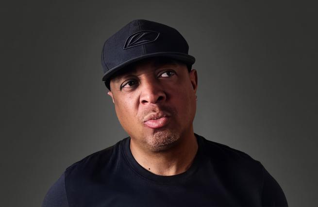 Image shows Chuck D who is headlining LIFI25 (a man in dark clothing looking to the side)