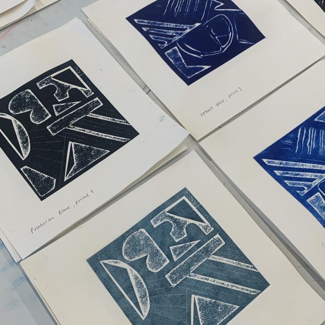 A flat lay of 4 collagraph prints in various shades of blue.