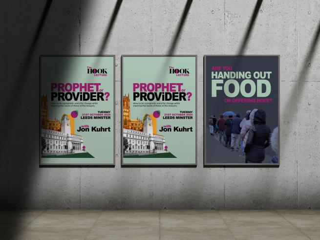 A noticeboard on a shadowy street advertises the Hook Lecture. The board next to it shows a queue of people, with the words 'Are you handing out food or offering hope?'