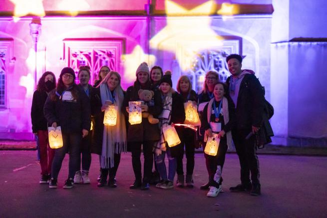 Group of friends with their lanterns that have their loved and missed babies names on.