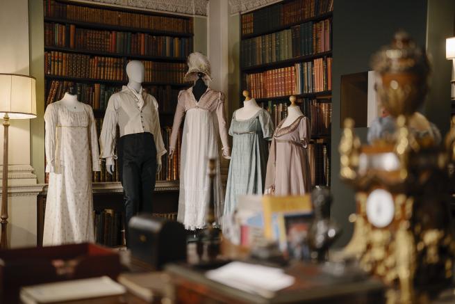 Mannequins display a variety of period clothing, showcasing historical fashion styles from different eras.