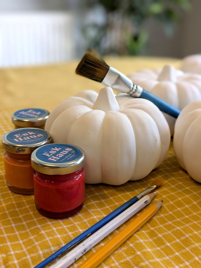 Small ceramic pumpkin with paint pots and paint brush