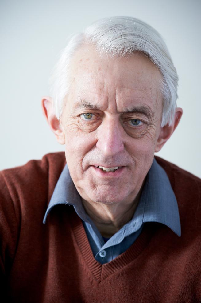 It shows a photo of Professor Paul Rogers