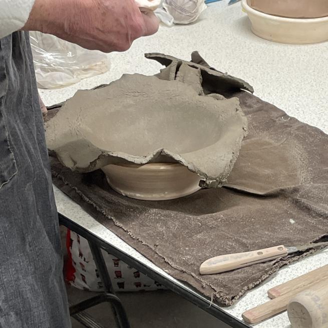 A clay bowl being made