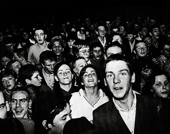 Black and white image of a young crowd of fans