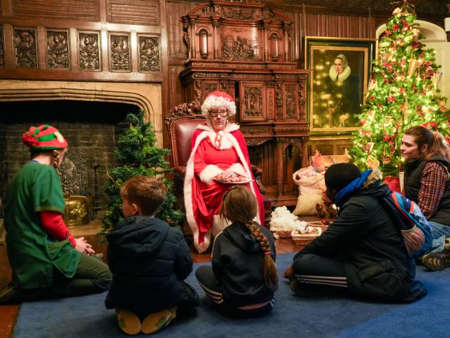 A group of people listening to festive storytime with Mrs Claus
