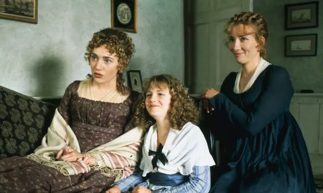 A young woman, a child and their mother look off-screen with bemused expressions.