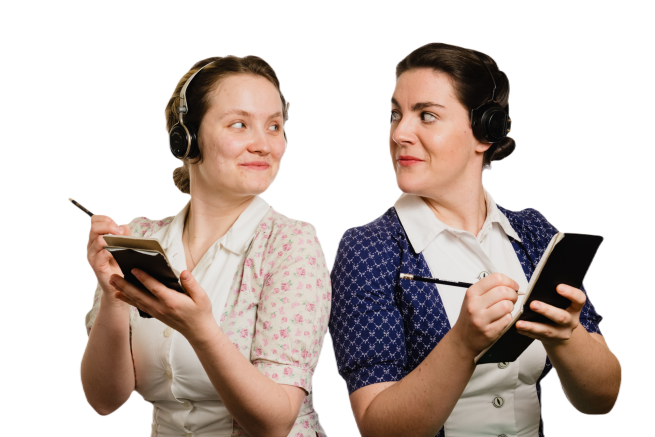 Two dark haired Women dressed in 1940's clothing and headsets look at each with warmth whilst writing code in their notepads 