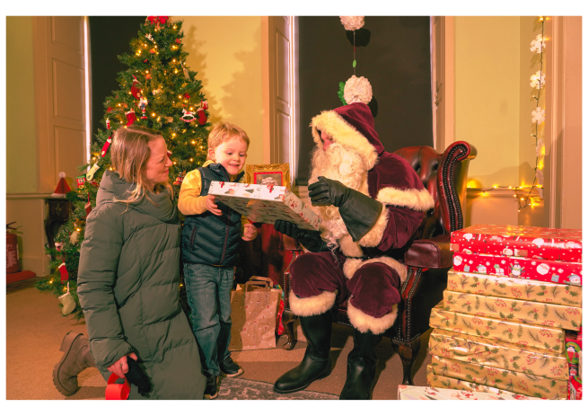 A family visiting Father Christmas at Temple Newsam