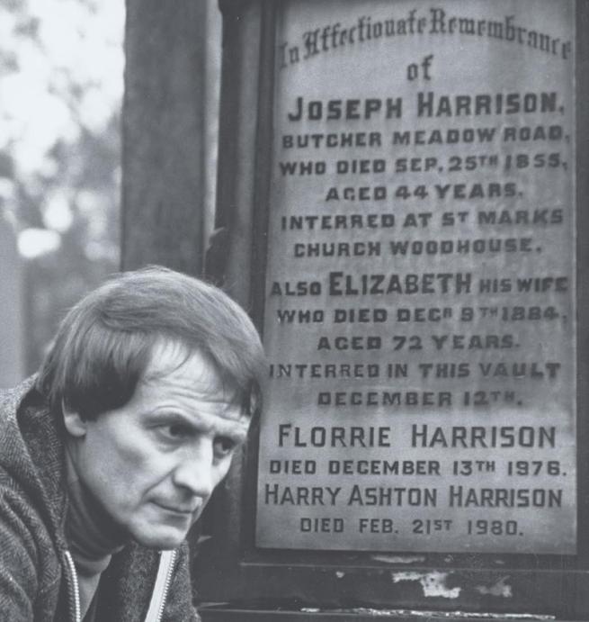 Tony Harrison in front of a gravestone