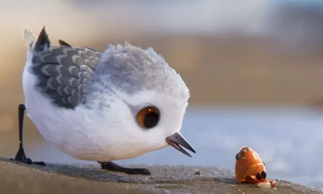 A cartoon white bird looks at some food on the ground.