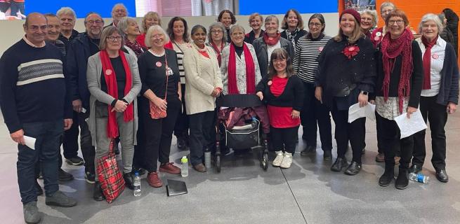 Members of Leeds People's Choir look happily at the camera after singing in Leeds Kirkgate Market
