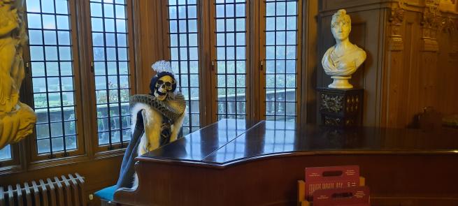 A skeleton playing the piano in the Great Hall at Temple Newsam