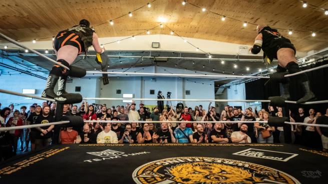 Will Kroos and Rampage Brown stand on the top turnbuckles posing to the Leeds crowd