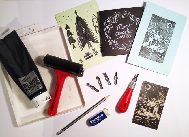 Various print making equipment, roller, ink, lino cutting tool, papers, inks and a few Christmas card ideas. 