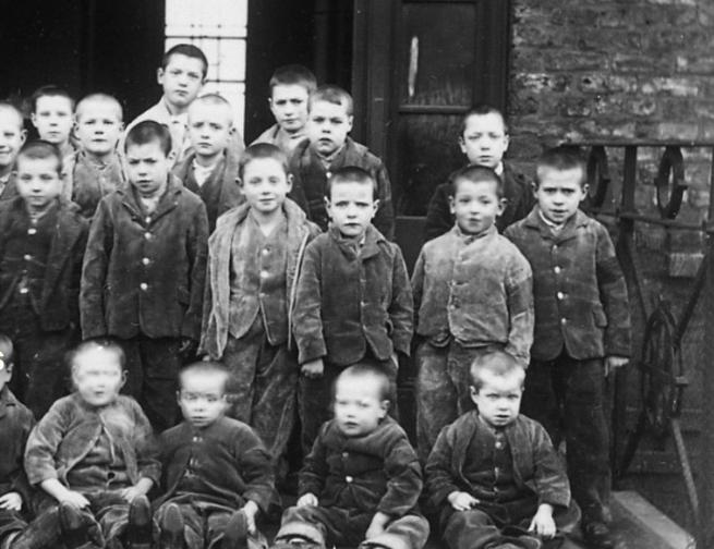 A black and white photo of children at a Victorian workhouse