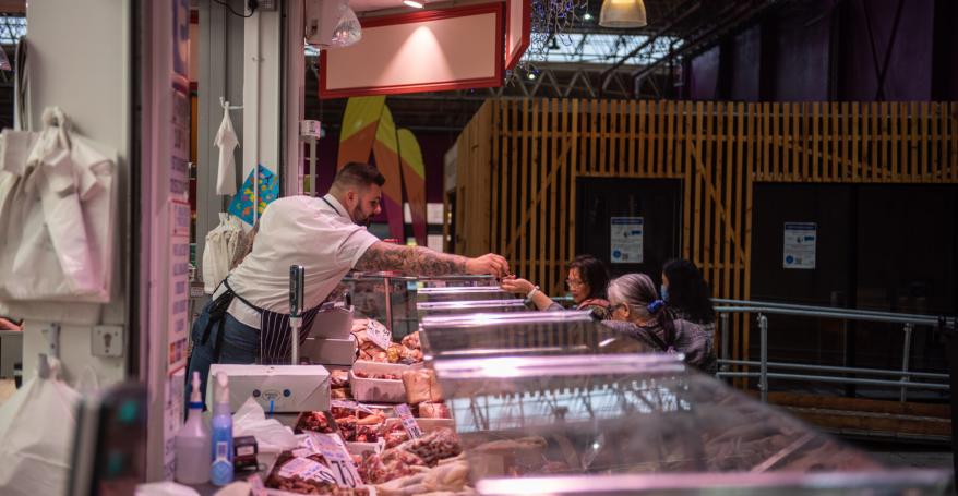 butcher selling meat to a customer