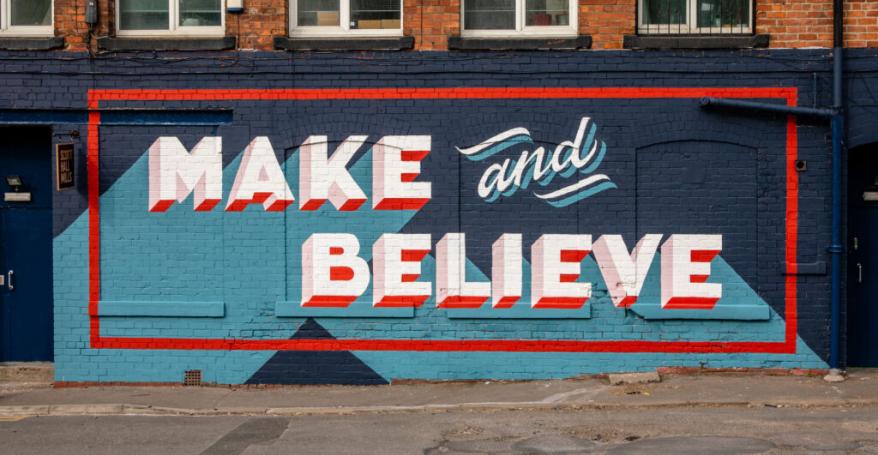 a mural in blue and red stating 'Make and Believe'
