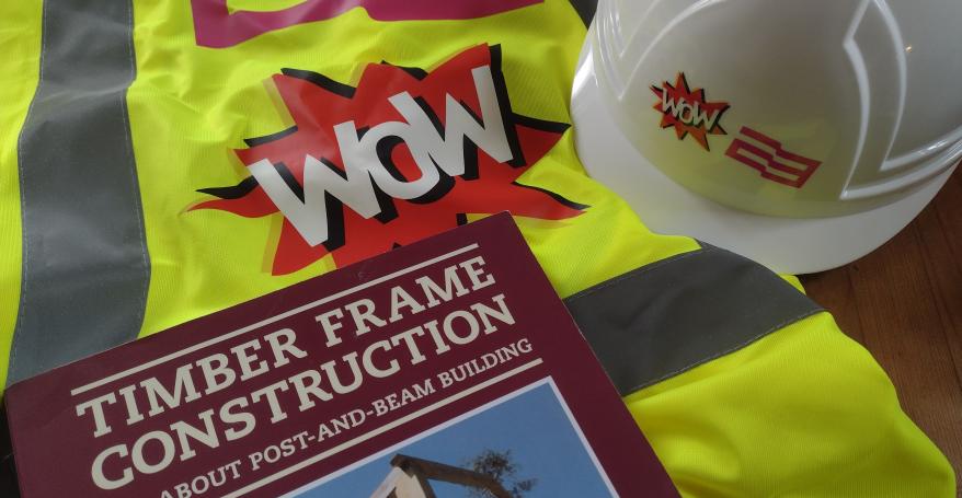 a book a hi vis jacket and a hard hat