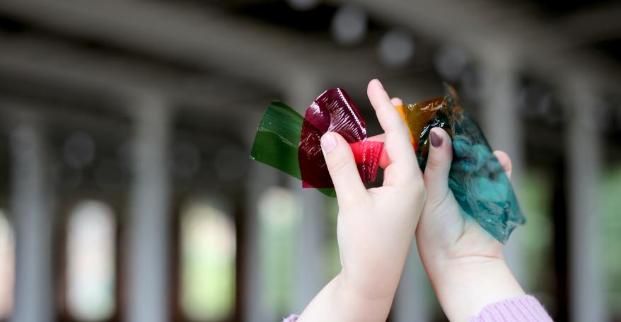 a child's hands holding something in the air