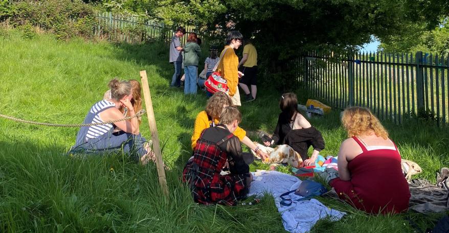 a group of young people on a grassy verge