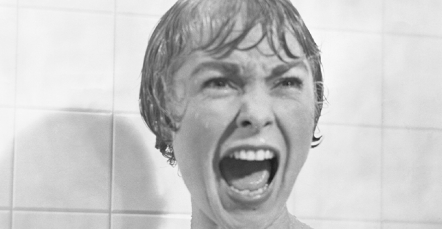 An iconic still from the film Psycho of Marion in the shower scene screaming