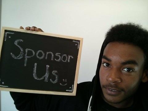 man holding a blackboard that says sponsor us