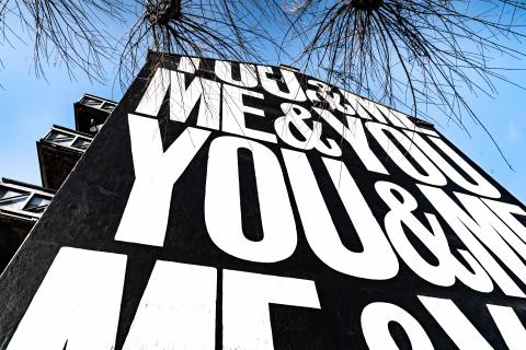 looking up from below of a building with writing on it