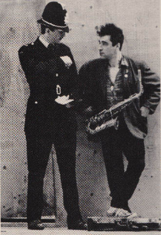 A policeman standing next to musician Xero Slingsby