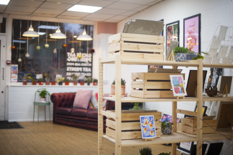 Image shows Beam Works interior with shelves and artwork.