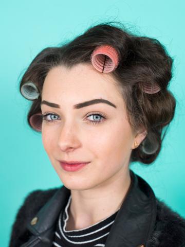 a young woman in hair rollers