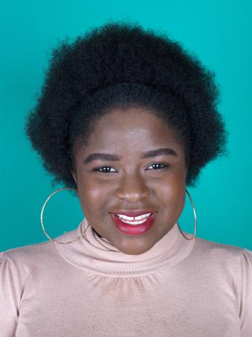 a young woman smiling directly at the camera