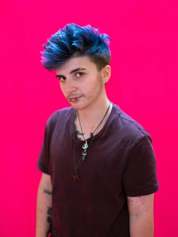 a young person with blue hair in a quiff