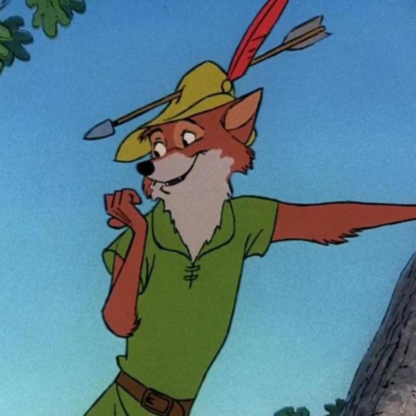 Image is of a cartoon fox wearing a green tunic and a hat, smiling and leaning against a tree.