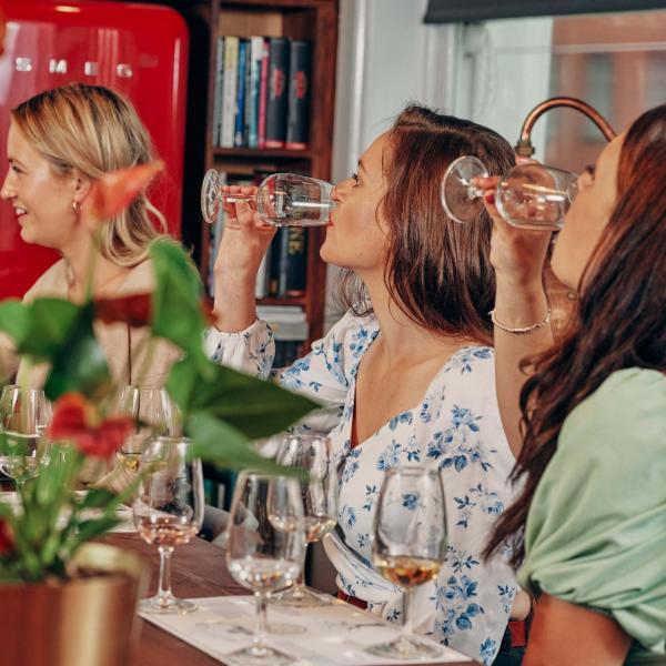 A group of people sip rum samples around a table