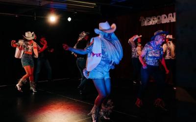 People dancing in cowboy hats and boots