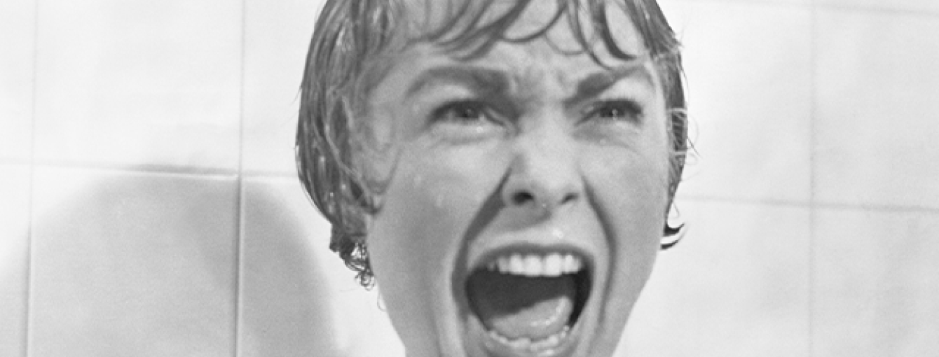 An iconic still from the film Psycho of Marion in the shower scene screaming